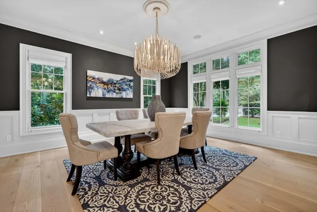 a living room with furniture chandelier and a fireplace