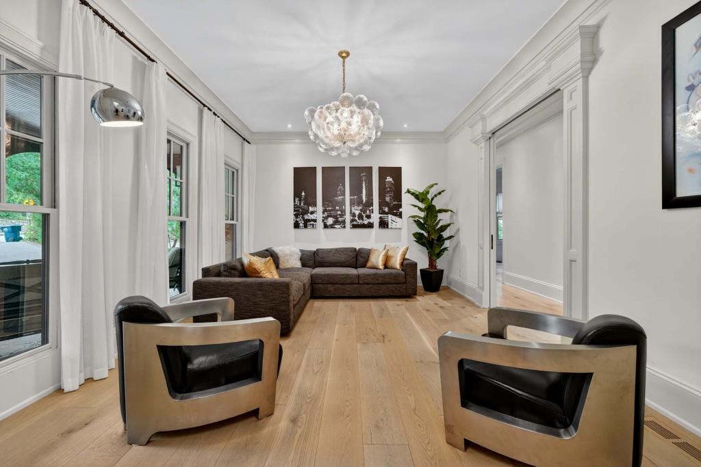 3303 Habersham Road Northwest Atlanta, GA 30305 - Photo 15 of 63 a living room with furniture chandelier and a fireplace