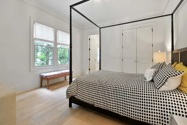 a view of an entryway with wooden floor and livingroom