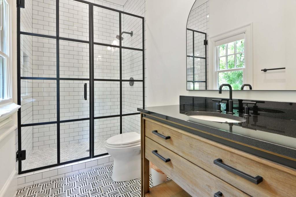 3303 Habersham Road Northwest Atlanta, GA 30305 - Photo 18 of 63 a bathroom with a sink a toilet and a window