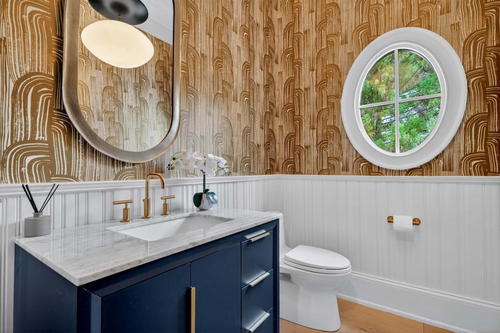 3303 Habersham Road Northwest Atlanta, GA 30305 - Photo 22 of 63 a bathroom with a toilet a sink and a mirror