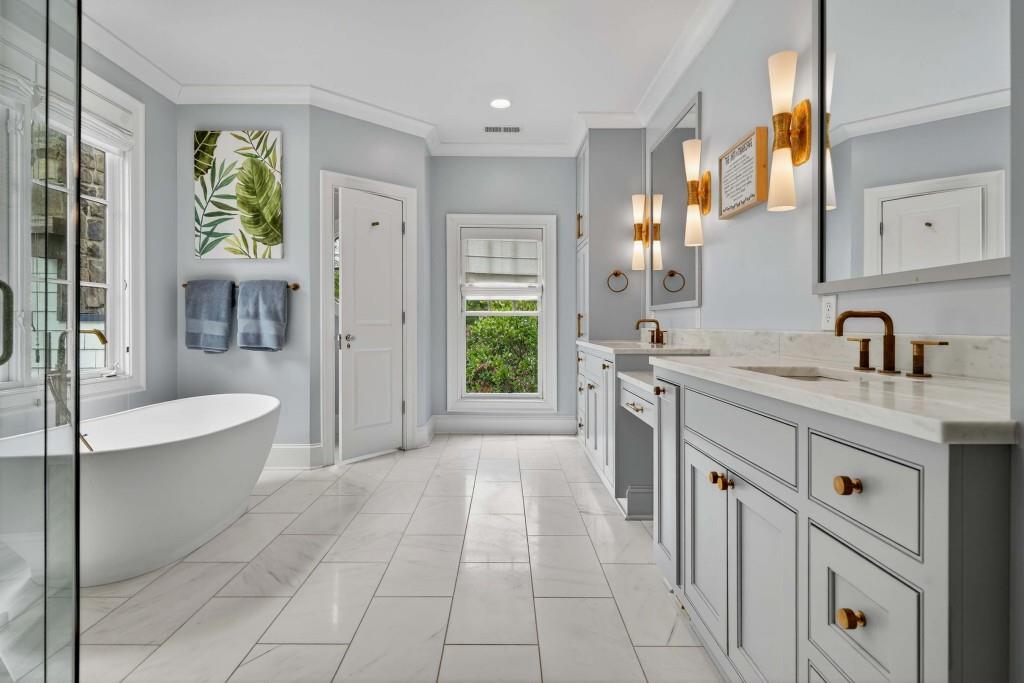 3303 Habersham Road Northwest Atlanta, GA 30305 - Photo 27 of 63 a spacious bathroom with a tub sink and mirror