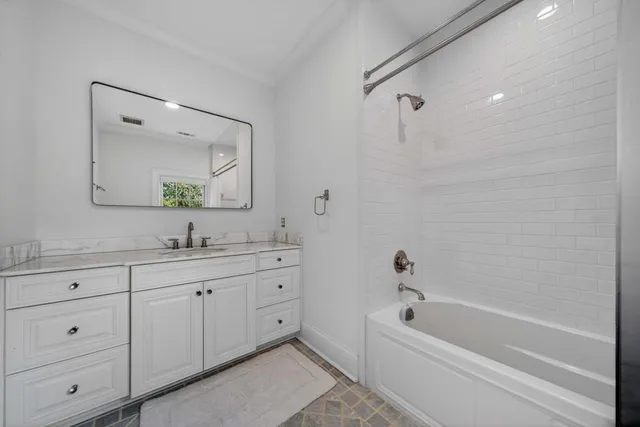 a bathroom with a granite countertop sink a toilet and a mirror