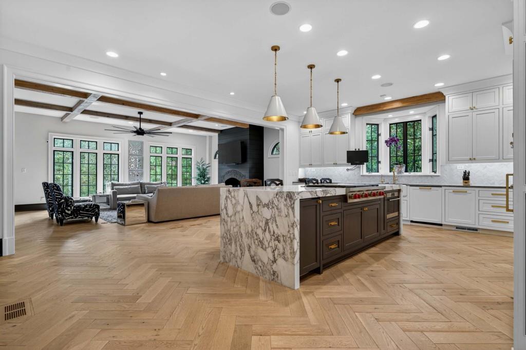 3303 Habersham Road Northwest Atlanta, GA 30305 - Photo 4 of 63 a large kitchen with stainless steel appliances kitchen island granite countertop a large counter top a couch and a view of living room