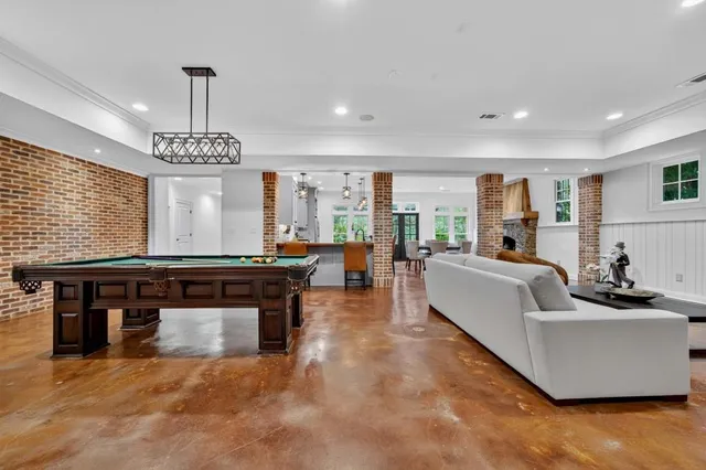 a living room with furniture a fireplace and a large window