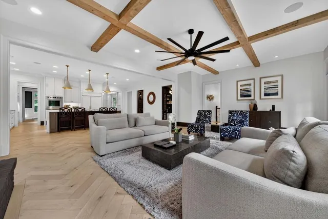 a large white kitchen with granite countertop a sink and dishwasher next to a window