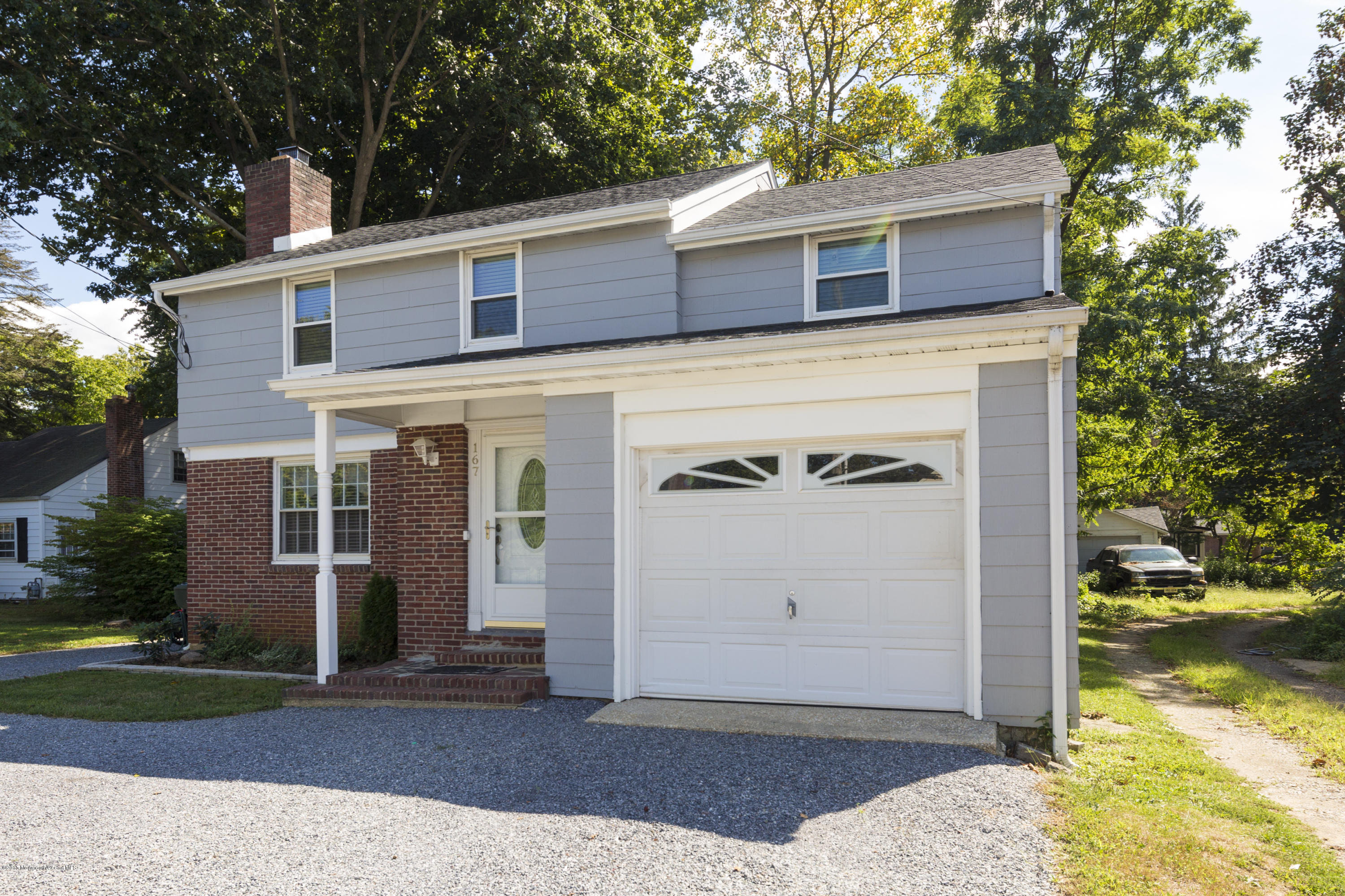 167 Newman Springs Road Tinton Falls, NJ 07724 - Photo 2 of 23 front view of a house with a yard
