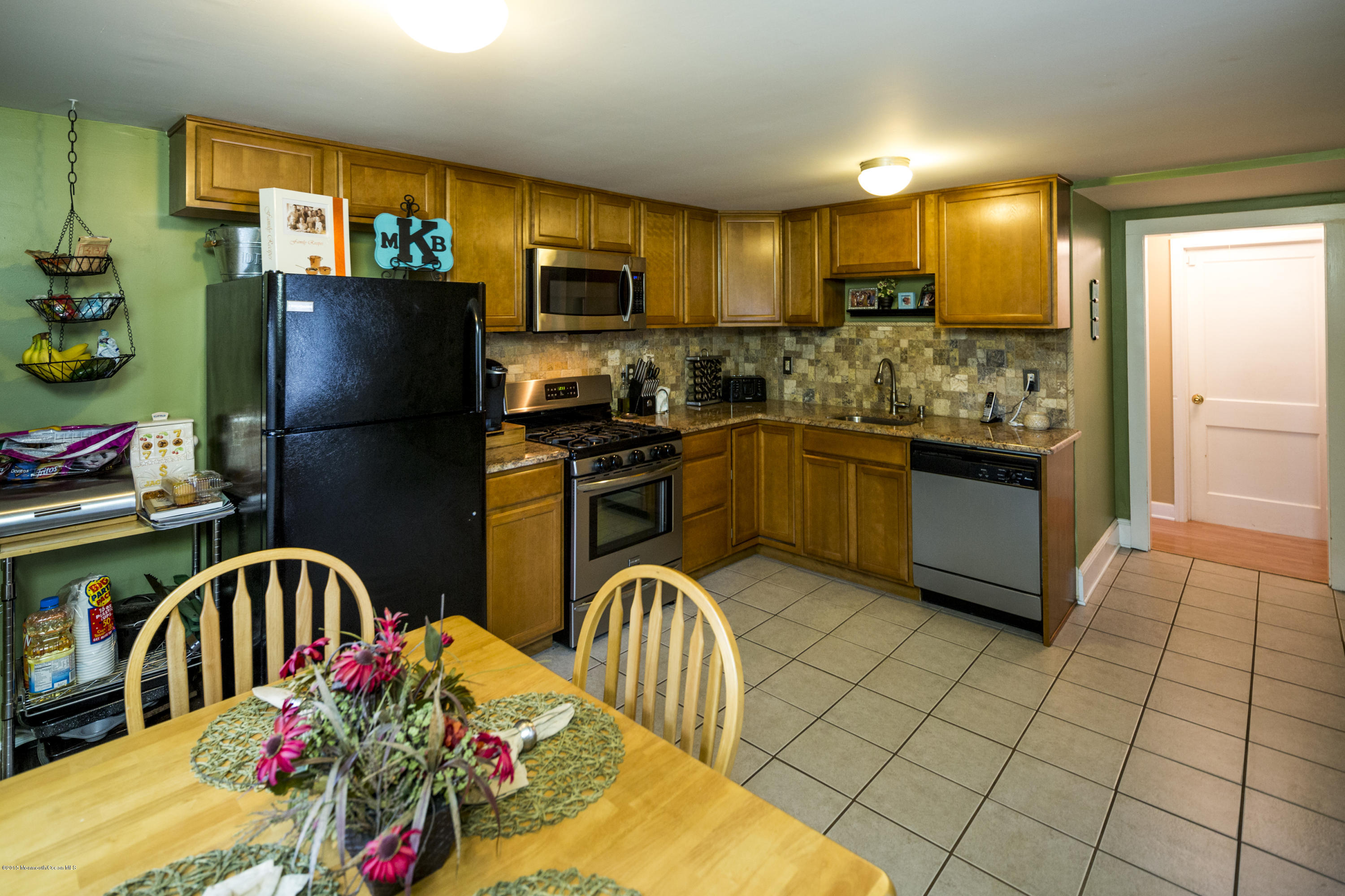 167 Newman Springs Road Tinton Falls, NJ 07724 - Photo 11 of 23 a kitchen with stainless steel appliances granite countertop a refrigerator and a stove top oven