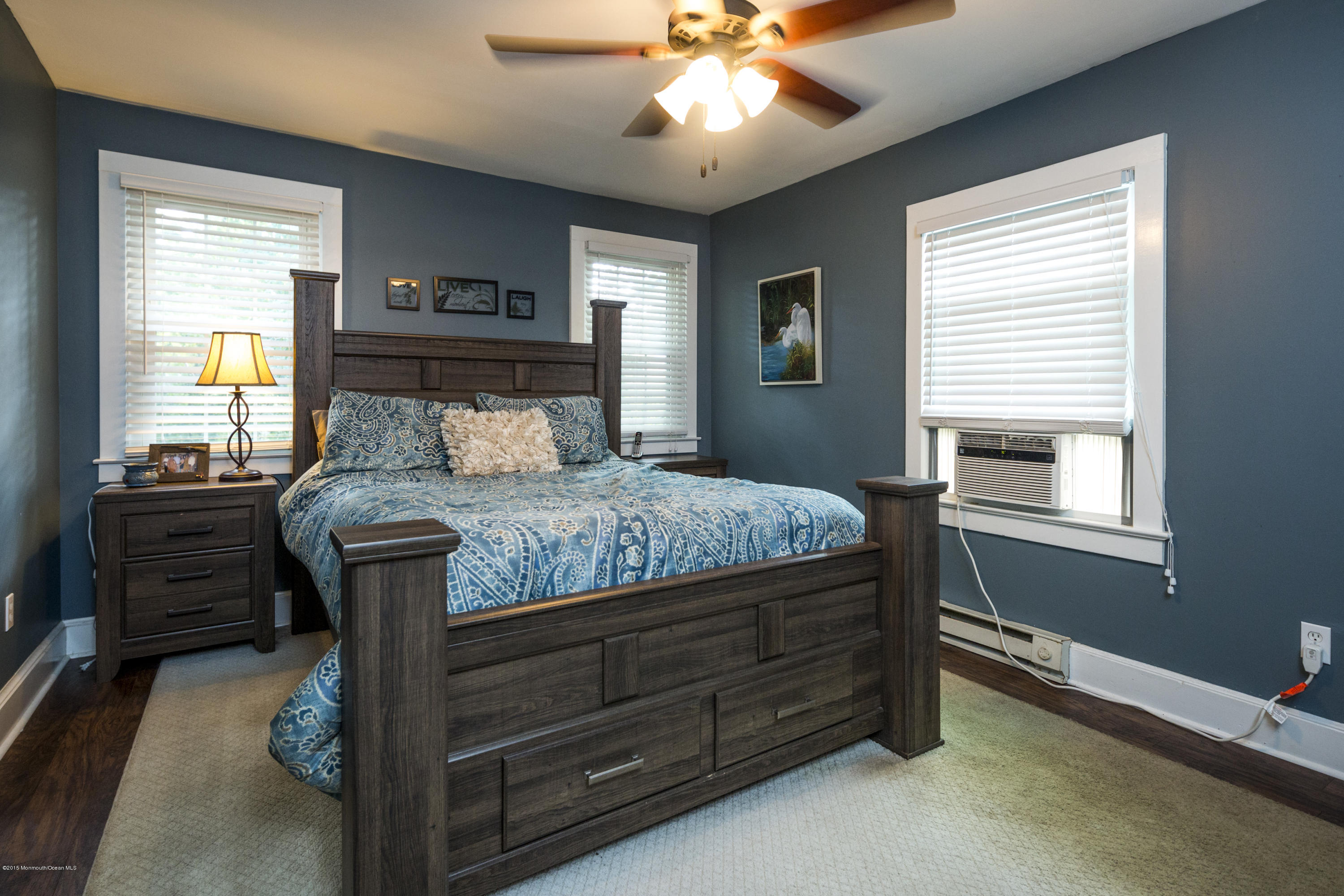 167 Newman Springs Road Tinton Falls, NJ 07724 - Photo 14 of 23 a bedroom with a bed and a chandelier