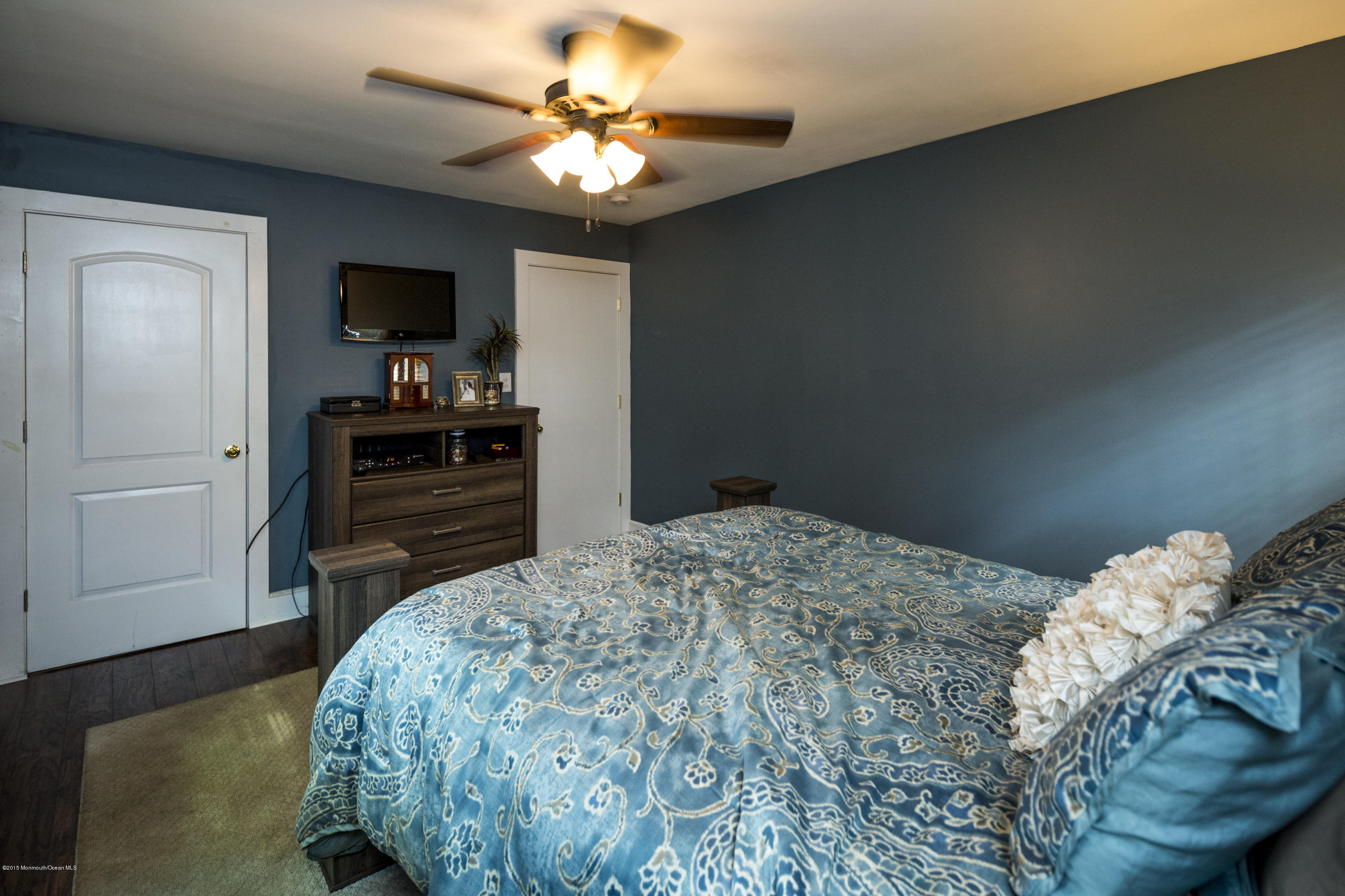 167 Newman Springs Road Tinton Falls, NJ 07724 - Photo 15 of 23 a bedroom with a bed and a flat screen tv