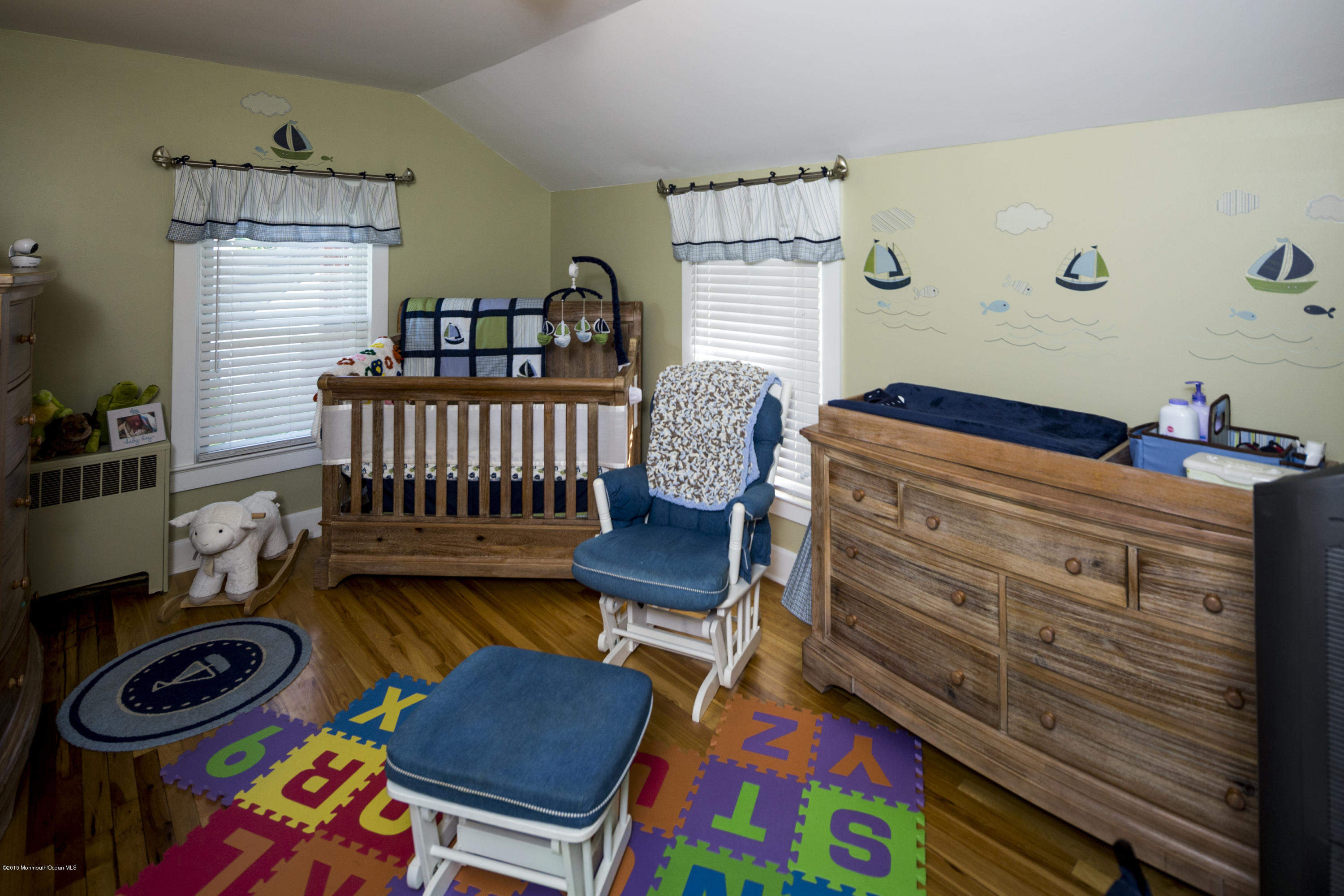 167 Newman Springs Road Tinton Falls, NJ 07724 - Photo 18 of 23 a bedroom with a baby bed a dresser and a window