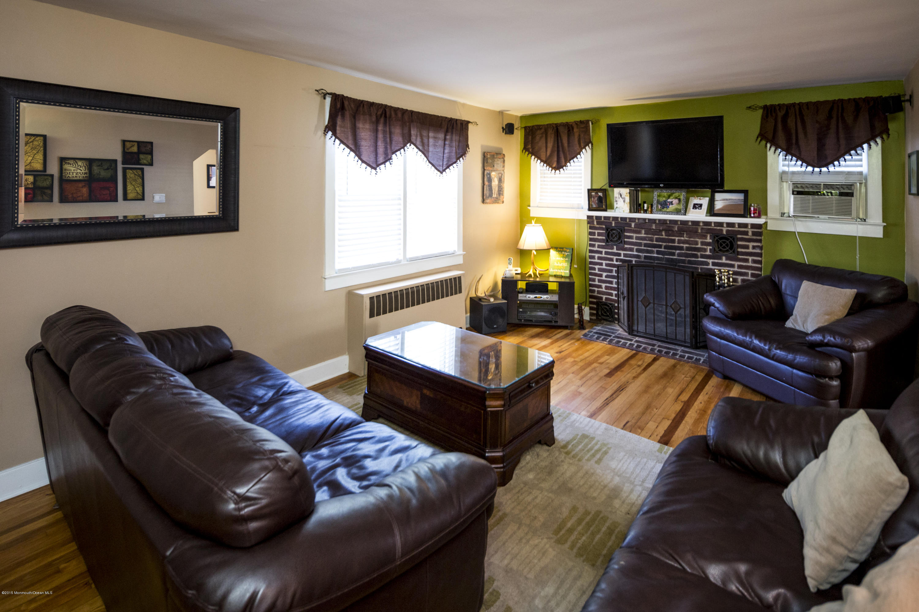 167 Newman Springs Road Tinton Falls, NJ 07724 - Photo 8 of 23 a living room with furniture fireplace and flat screen tv