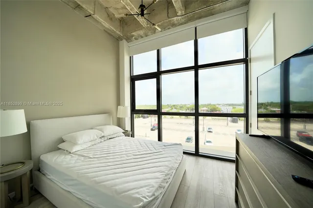 a bathroom with a large window and a bed