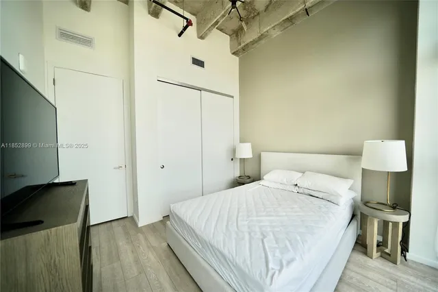 a bedroom with a bed and a lamp on table