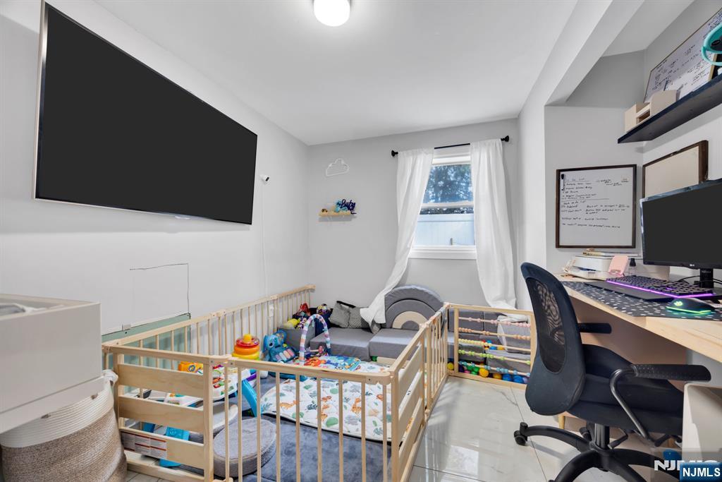 241 Orange Street Dunellen, NJ 08812 - Photo 18 of 35 a view of a workspace with furniture and a flat screen tv