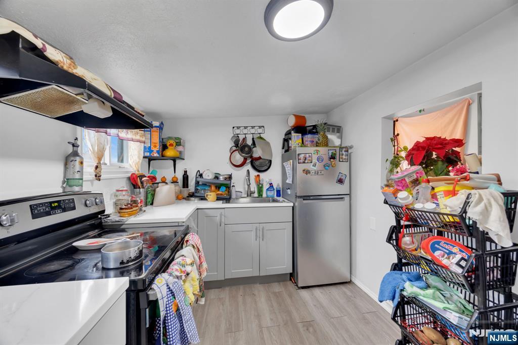 241 Orange Street Dunellen, NJ 08812 - Photo 19 of 35 a kitchen that has a lot of cabinets a refrigerator and a stove