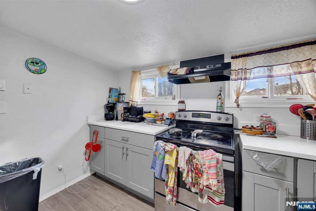 241 Orange Street Dunellen, NJ 08812 - Photo 21 of 35 a kitchen with stainless steel appliances a stove a sink and cabinets