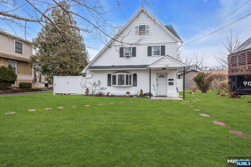 241 Orange Street Dunellen, NJ 08812 - Photo 3 of 35 a front view of a house with a garden