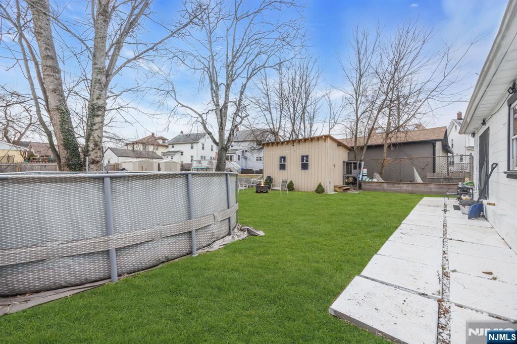 241 Orange Street Dunellen, NJ 08812 - Photo 32 of 35 a view of a white house with a big yard and large tree