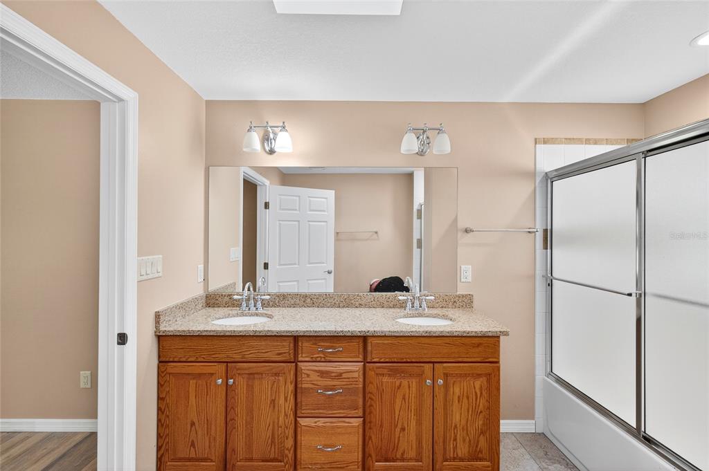201 West Street Interlachen, FL 32148 - Photo 12 of 43 a bathroom with a granite countertop sink and a mirror