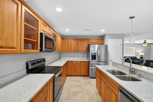 a kitchen with stainless steel appliances granite countertop a sink and stove