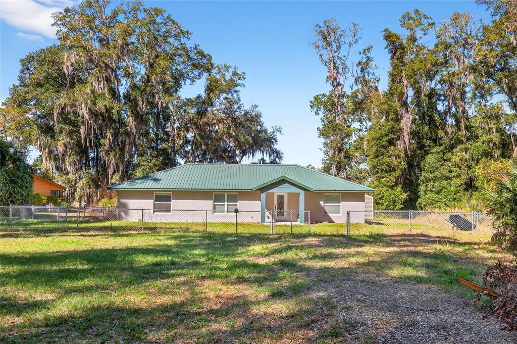 201 West Street Interlachen, FL 32148 - Photo 2 of 43 a front view of a house with garden