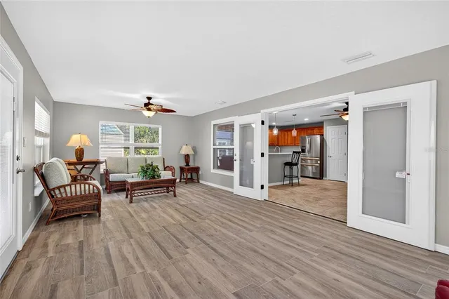 a living room with furniture and a wooden floor