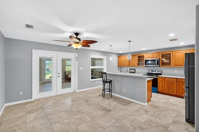 a view of kitchen with sink refrigerator and microwave