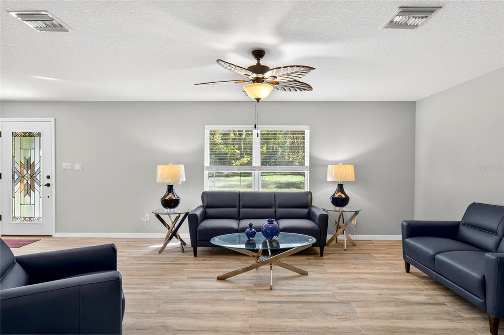 201 West Street Interlachen, FL 32148 - Photo 6 of 43 a living room with furniture and a window