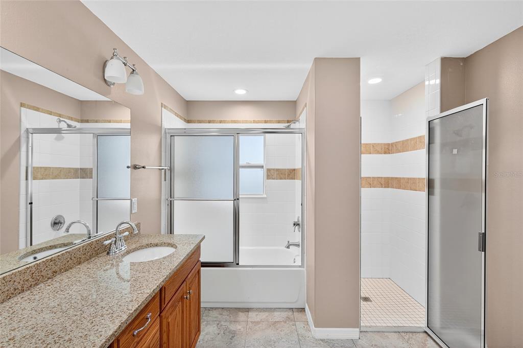 201 West Street Interlachen, FL 32148 - Photo 10 of 43 a bathroom with a granite countertop sink mirror and shower