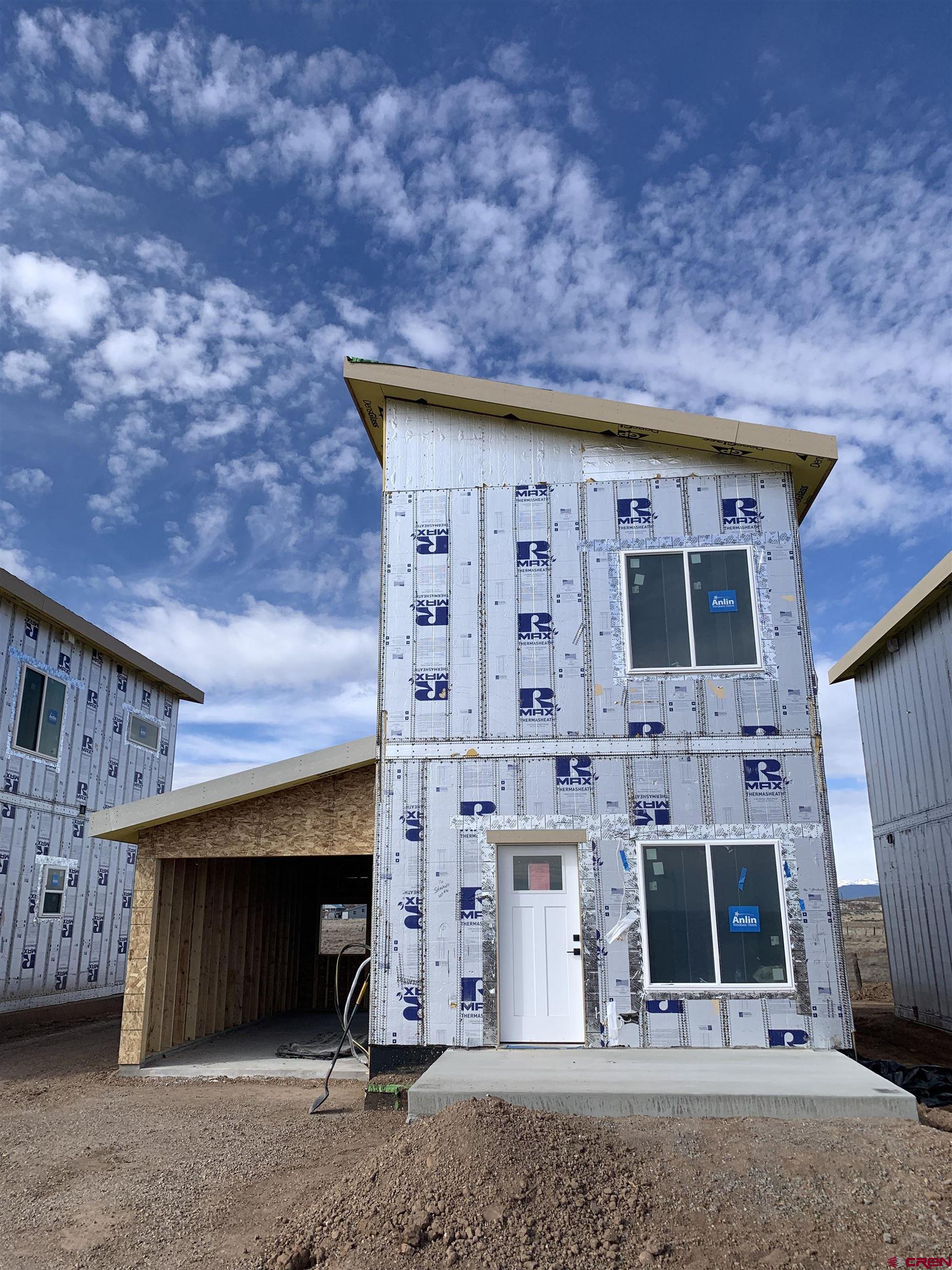 250 Manzano Circle Ignacio, CO 81137 - Photo 12 of 12 a front view of a house with barbeque grill and outdoor seating