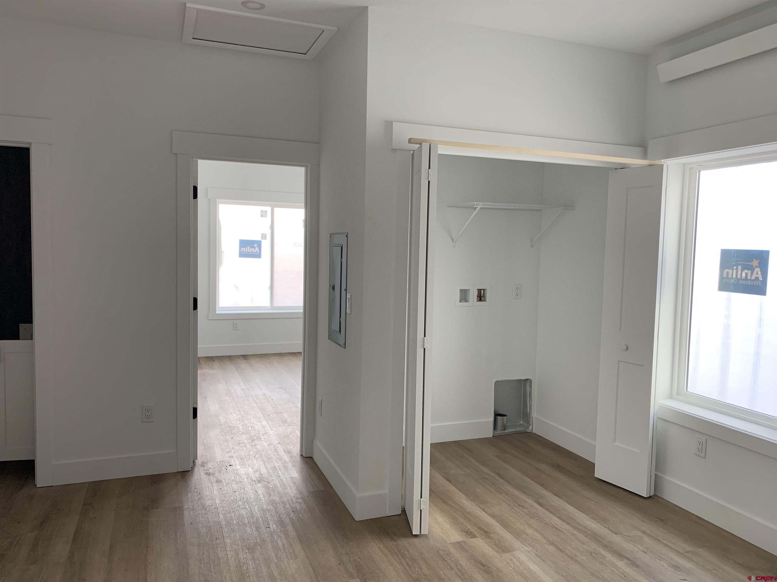 250 Manzano Circle Ignacio, CO 81137 - Photo 9 of 12 an empty room with wooden floor and windows