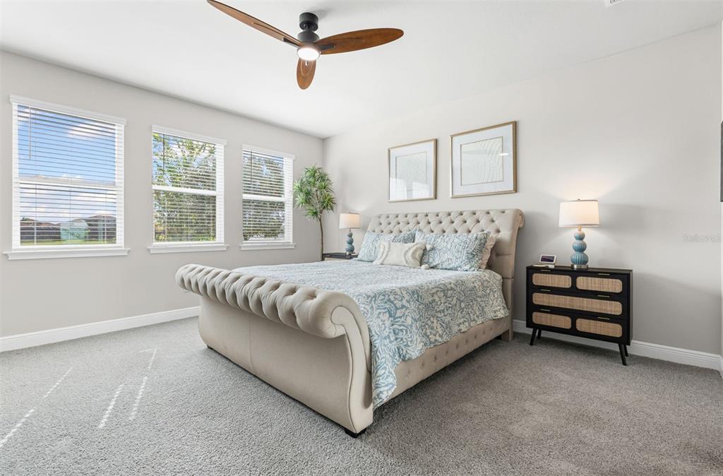 20380 Symphony Place Venice, FL 34293 - Photo 15 of 56 a bedroom with a bed lamp and a large window