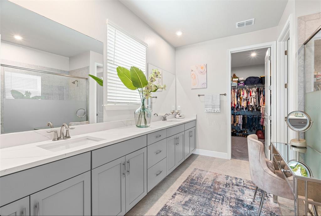 20380 Symphony Place Venice, FL 34293 - Photo 18 of 56 a spacious bathroom with a double vanity sink and a mirror