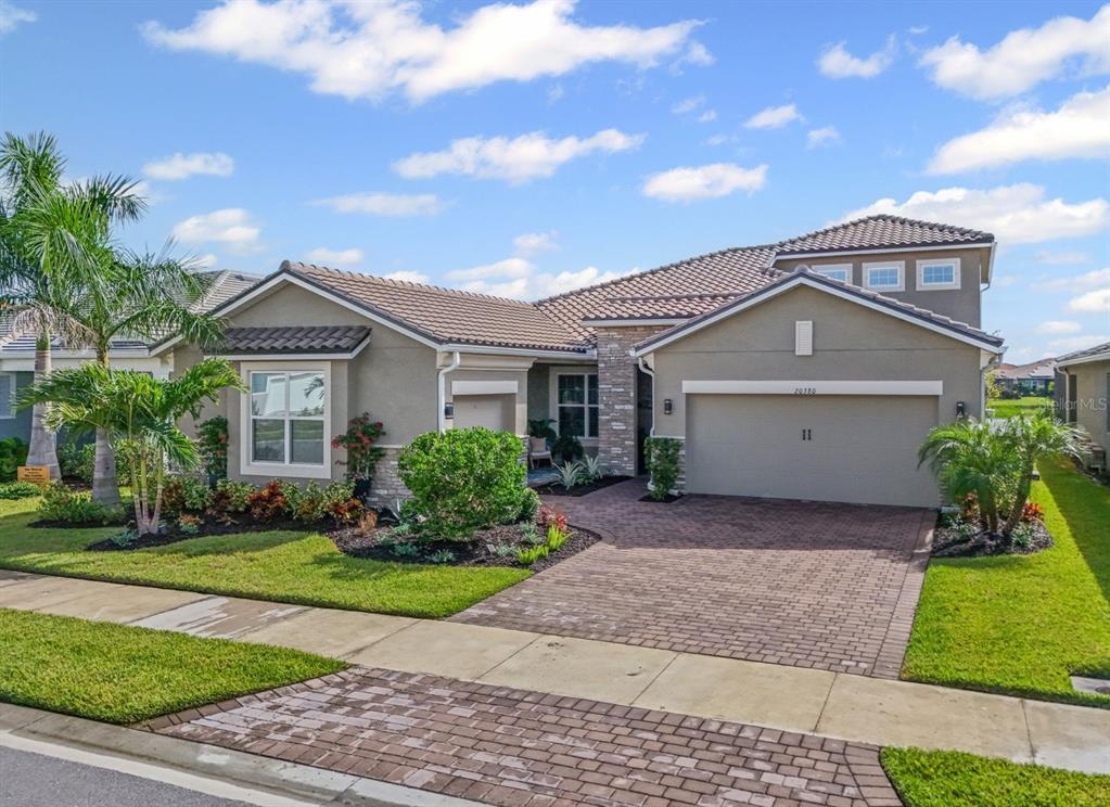 20380 Symphony Place Venice, FL 34293 - Photo 2 of 56 a front view of a house with a yard and garage