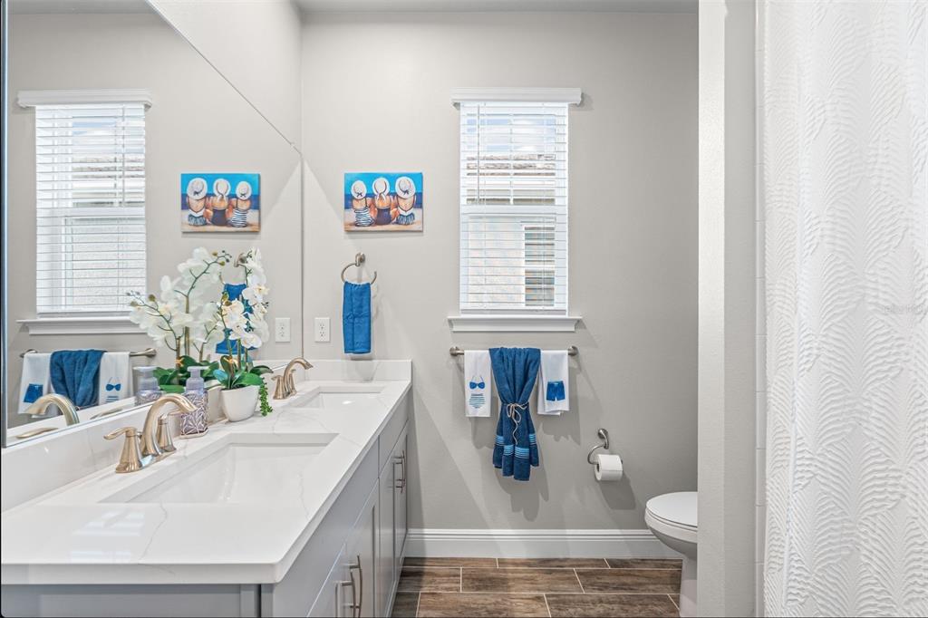 20380 Symphony Place Venice, FL 34293 - Photo 21 of 56 a bathroom with a sink mirror and window