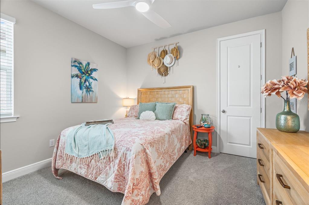 20380 Symphony Place Venice, FL 34293 - Photo 23 of 56 a bedroom with a bed and a table