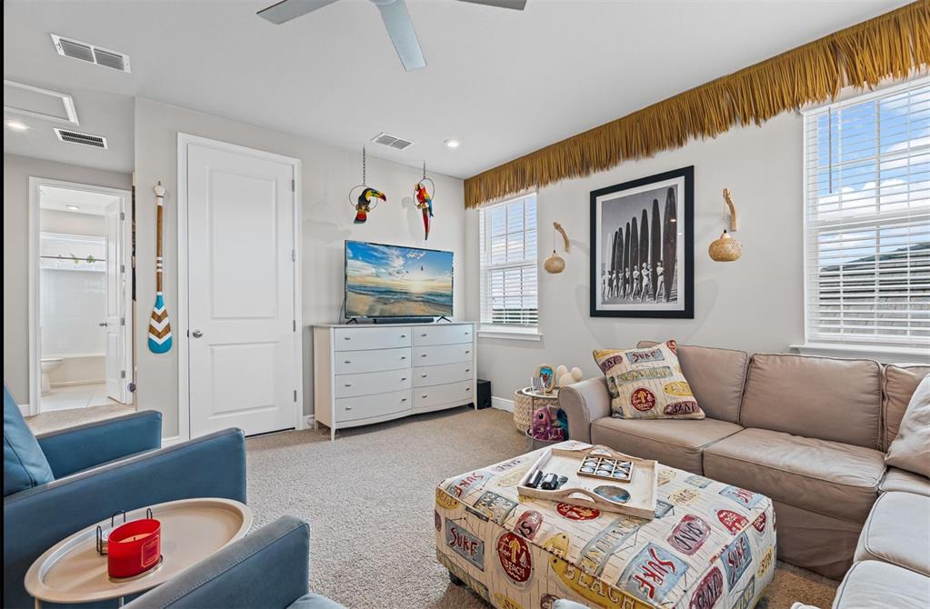20380 Symphony Place Venice, FL 34293 - Photo 30 of 56 a living room with furniture and a flat screen tv