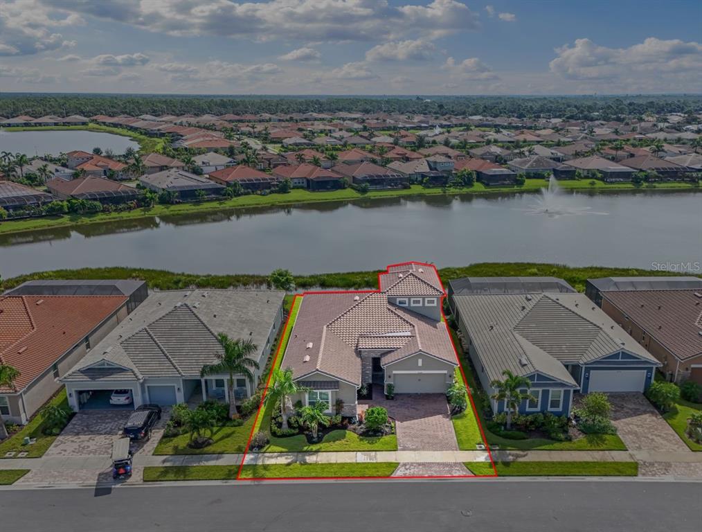 20380 Symphony Place Venice, FL 34293 - Photo 3 of 56 an aerial view of a house with a lake view