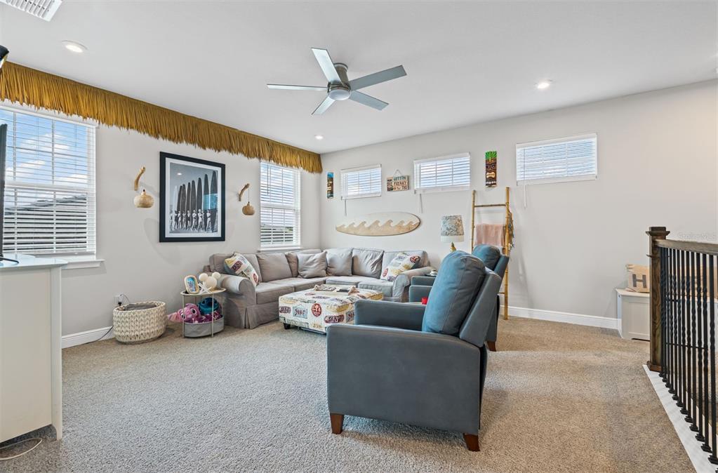 20380 Symphony Place Venice, FL 34293 - Photo 31 of 56 a living room with furniture and two window