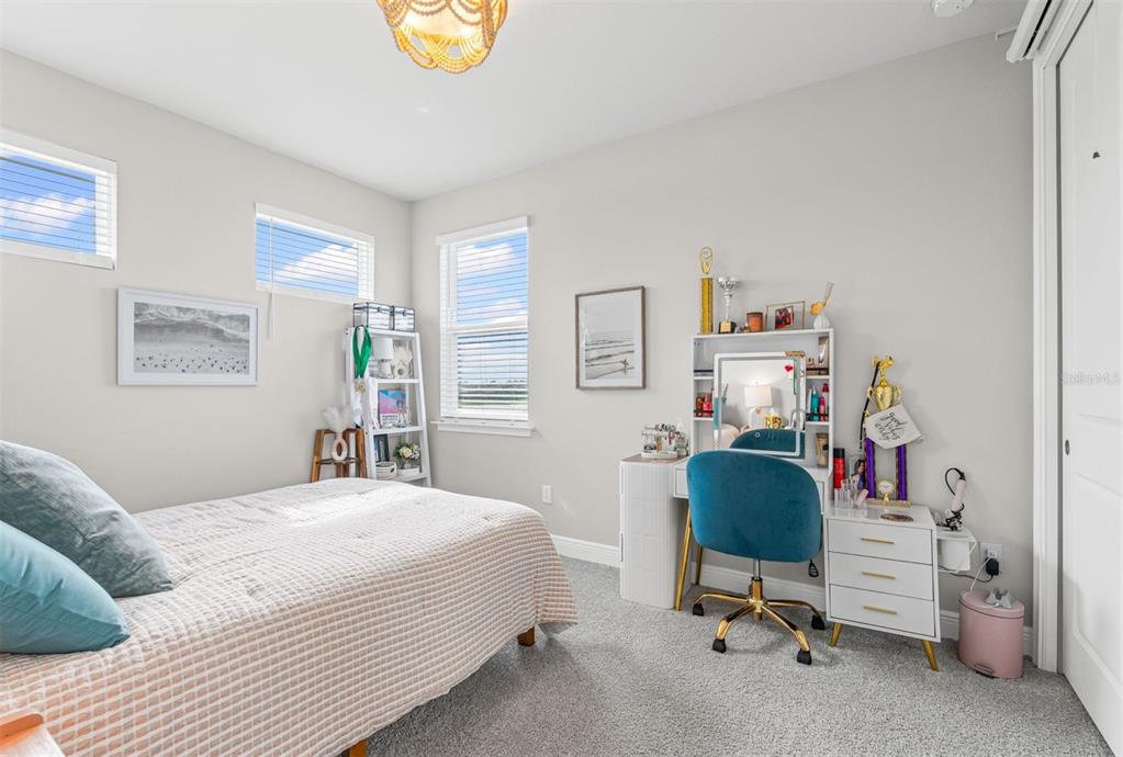 20380 Symphony Place Venice, FL 34293 - Photo 32 of 56 a bedroom with a workspace and a couch