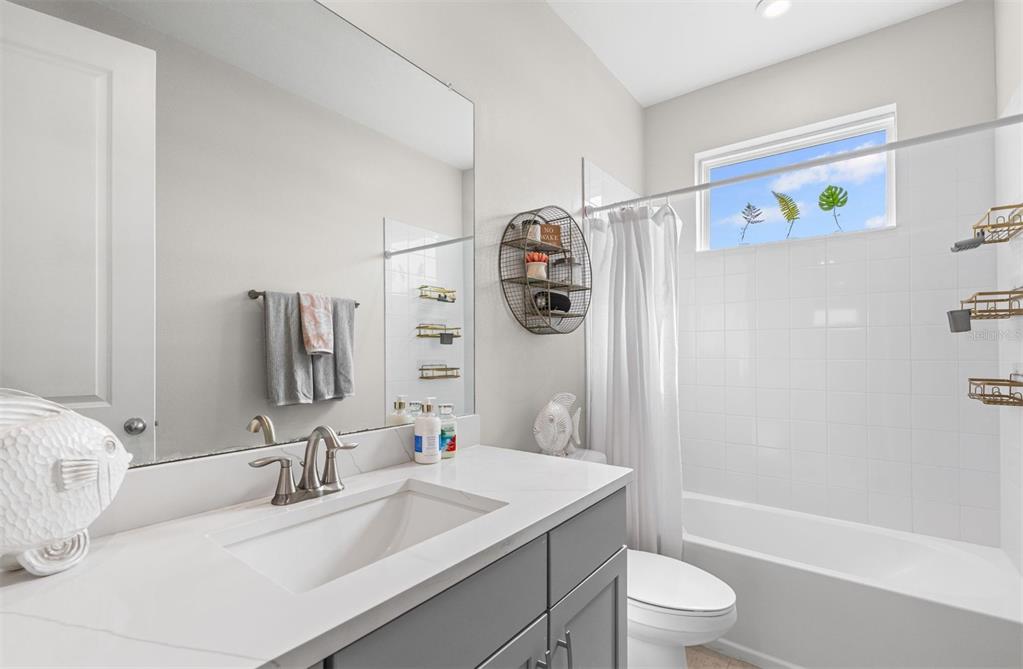 20380 Symphony Place Venice, FL 34293 - Photo 33 of 56 a bathroom with a sink toilet and shower