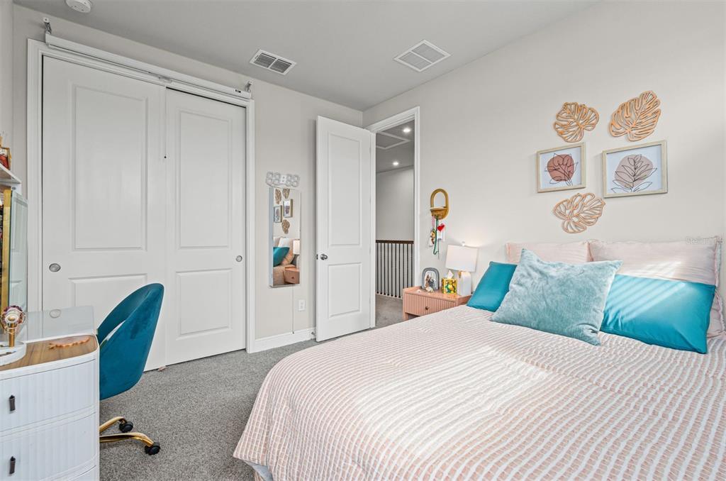 20380 Symphony Place Venice, FL 34293 - Photo 34 of 56 a bedroom with a bed and a chair in it