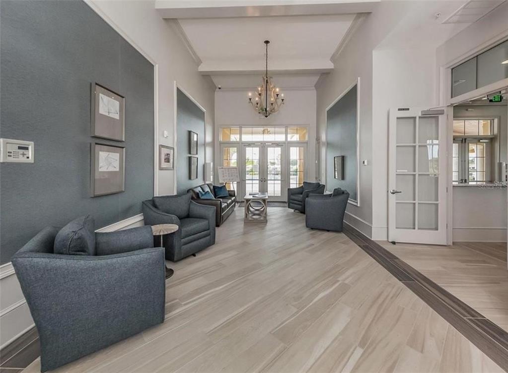 20380 Symphony Place Venice, FL 34293 - Photo 42 of 56 a living room with furniture and a chandelier
