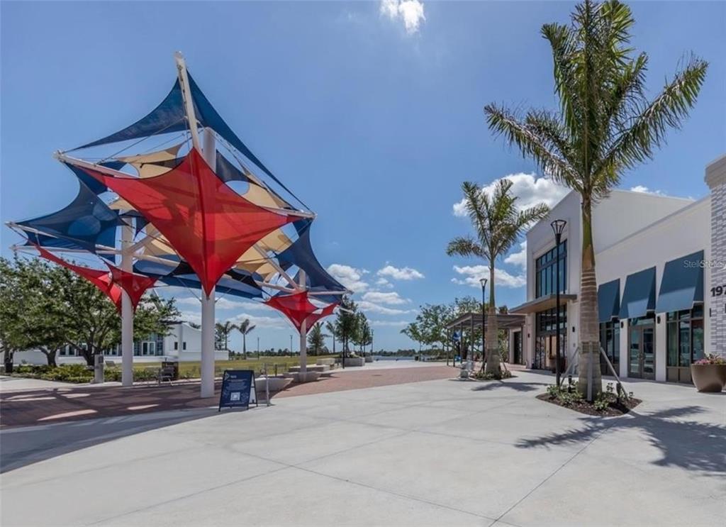20380 Symphony Place Venice, FL 34293 - Photo 47 of 56 a group of people sitting in front of a building