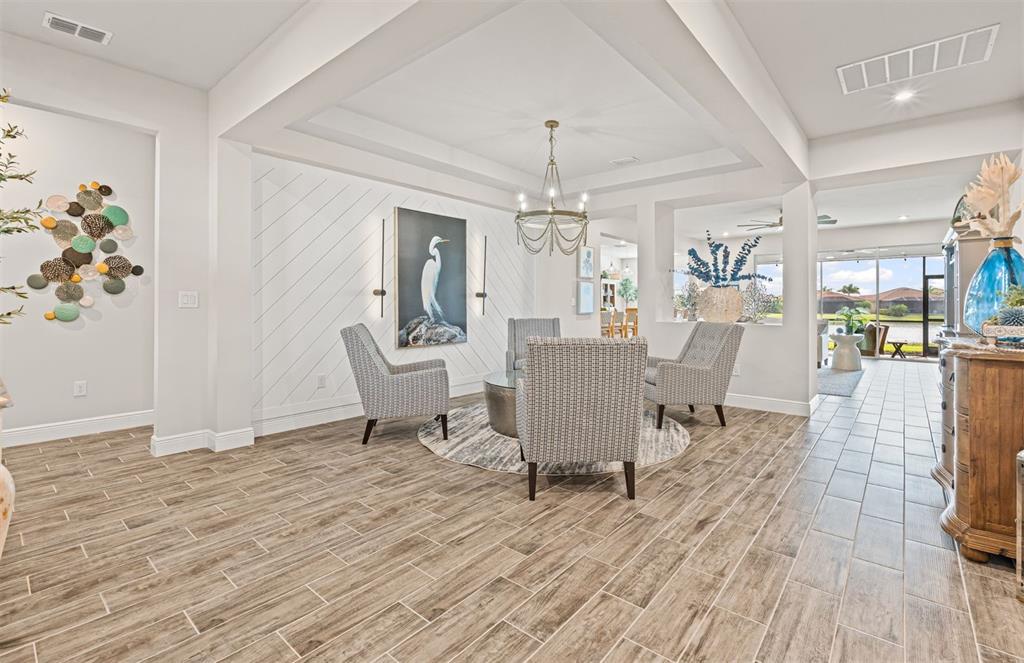20380 Symphony Place Venice, FL 34293 - Photo 5 of 56 a living room with furniture and a wooden floor