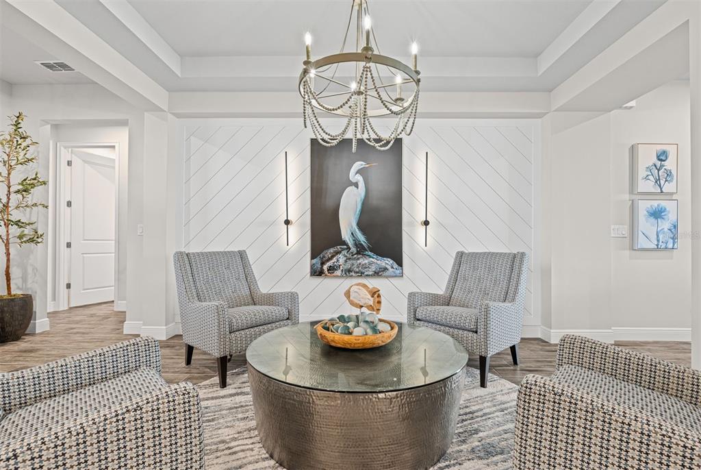 20380 Symphony Place Venice, FL 34293 - Photo 7 of 56 a living room with furniture and a chandelier