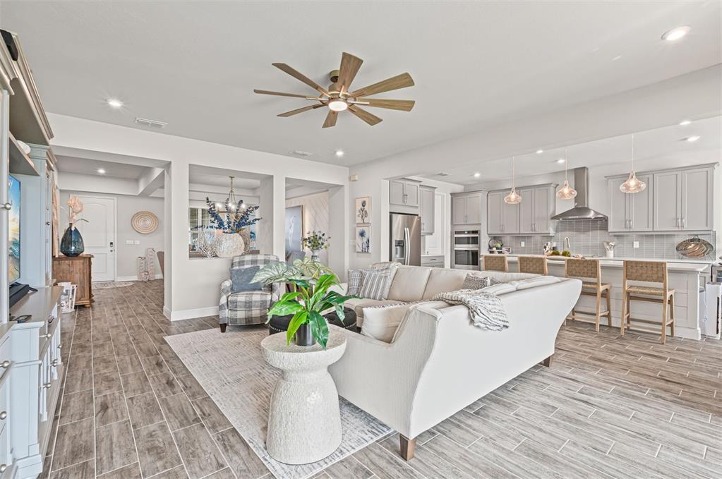20380 Symphony Place Venice, FL 34293 - Photo 8 of 56 a living room with furniture and a view of kitchen