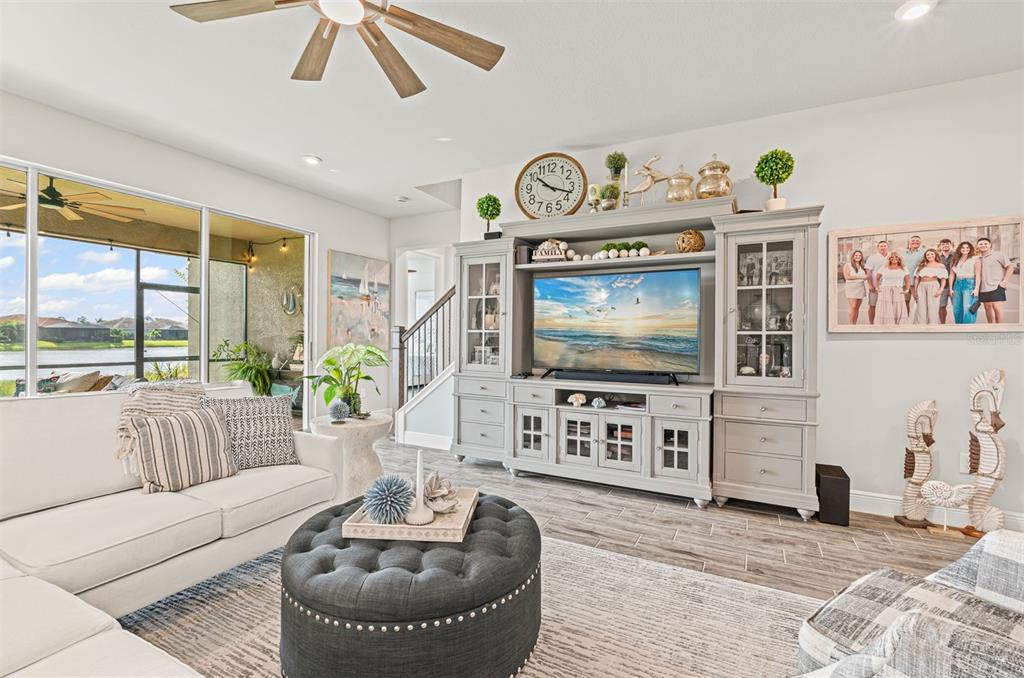 20380 Symphony Place Venice, FL 34293 - Photo 10 of 56 a living room with furniture and a flat screen tv