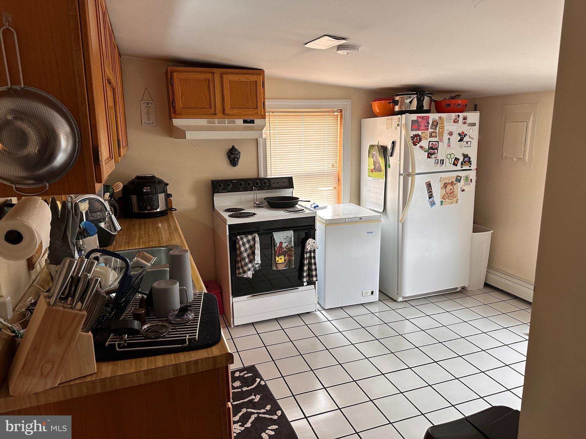 152 North Main Street Chalfont, PA 18914 - Photo 15 of 19 a view of a kitchen with fridge and workspace